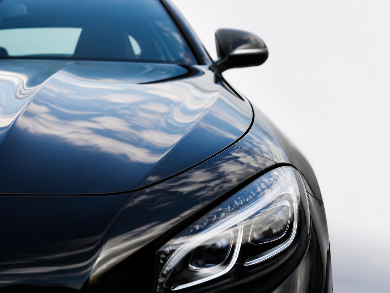 Close-up of a polished car hood with a deep gloss finish